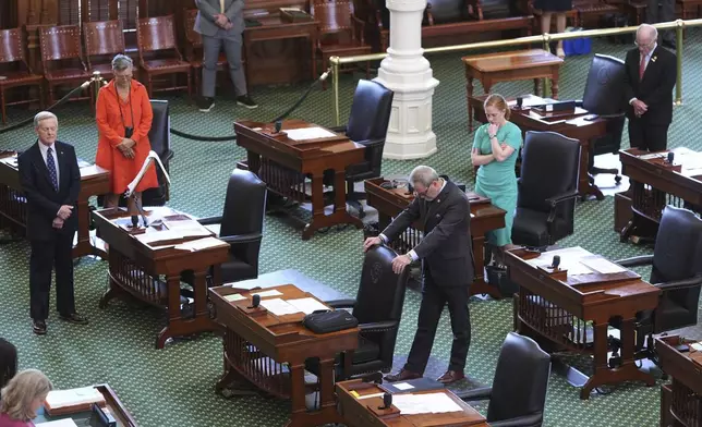 Texas state senators pray before they debate a bill on a redrawn U.S. congressional map during a special session in the Senate Chamber at the Texas Capitol in Austin, Texas, Friday, Aug. 22, 2025. (AP Photo/Eric Gay)