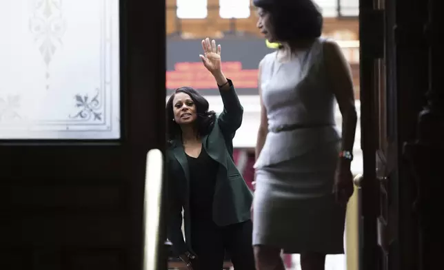 Texas state Rep. Nicole Collier, left, waves past Texas state Sen. Carol Alvarado, right, to supporters outside of the House Chamber where she refuses to leave due to a required law enforcement escort, Tuesday, Aug. 19, 2025, in Austin, Texas. (AP Photo/Eric Gay)