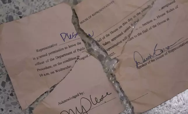 Democratic Texas state Rep. Plesa's ripped up 'permission slip' is seen outside the House Chamber after she and other democrats joined fellow Rep. Nicole Collier who refuses to leave due to a required law enforcement escort, Tuesday, Aug. 19, 2025, in Austin, Texas. (AP Photo/Eric Gay)