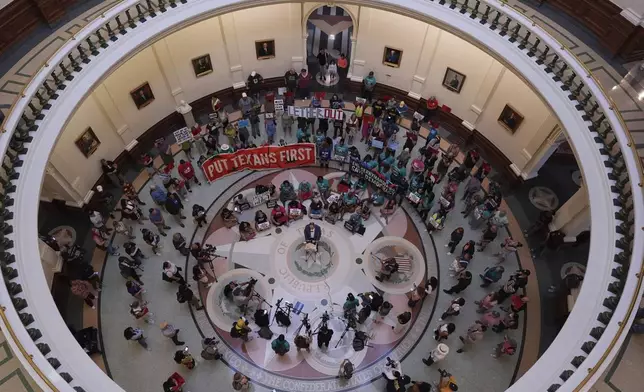 Protesters gather in the rotunda outside the House Chamber at the Texas Capitol as lawmakers debate a redrawn U.S. congressional map in Texas during a special, Wednesday, Aug. 20, 2025, in Austin, Texas. (AP Photo/Eric Gay)