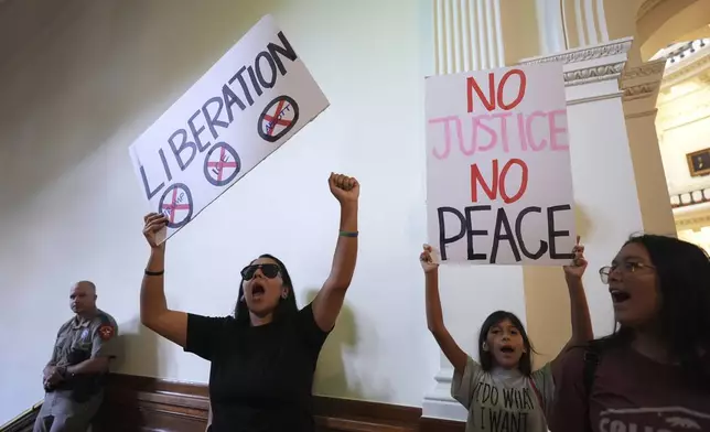 Protesters chant outside of the House Chamber where Democratic Texas Rep. Nicole Collier refuses to leave due to a required law enforcement escort, Tuesday, Aug. 19, 2025, in Austin, Texas. (AP Photo/Eric Gay)