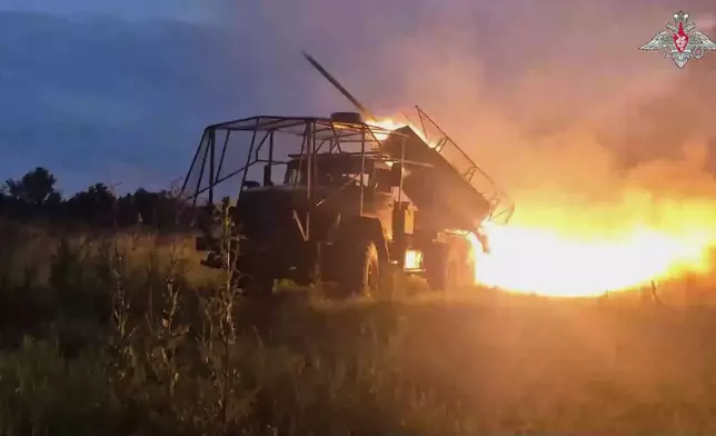 In this photo taken from video distributed by Russian Defense Ministry Press Service on Monday, Aug. 18, 2025, a Russian Army BM-21 "Grad" self-propelled 122 mm multiple rocket launcher fires towards Ukrainian position in an undisclosed location in Ukraine. (Russian Defense Ministry Press Service via AP)