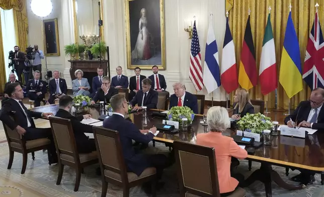 President Donald Trump, center, speaks as from foreground right, European Commission President Ursula von der Leyen, Finland's President Alexander Stubb, Ukrainian President Volodymyr Zelenskyy, NATO Secretary General Mark Rutte, and from center right, Germany's Chancellor Friedrich Merz, Italy's Prime Minister Giorgia Meloni, France's President Emmanuel Macron and British Prime Minister Keir Starmer participate in a meeting as Vice President JD Vance, from background right, Secretary of State Marco Rubio, Treasury Secretary Scott Bessent, Defense Secretary Pete Hegseth, White House Chief of Staff Susie Wiles and Special Presidential Envoy Steve Witkoff listen in the East Room of the White House, Monday, Aug. 18, 2025, in Washington. (AP Photo/Alex Brandon)