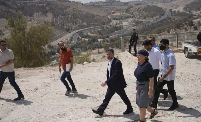 CORRECTS DAY Israeli Finance Minister Bezalel Smotrich arrives for a press conference about new settlement construction in the Israel-occupied West Bank near Maale Adumim, Thursday, Aug. 14, 2025. (AP Photo/Ohad Zwigenberg)