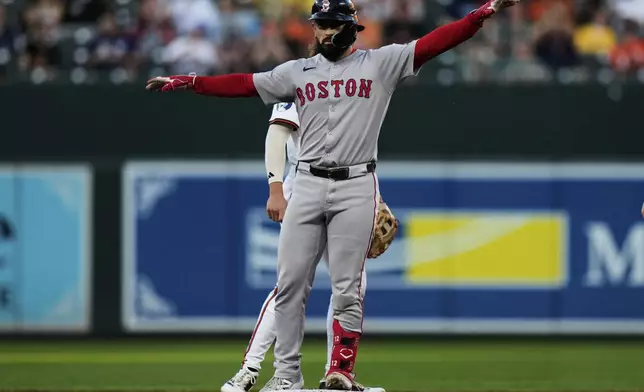 Boston Red Sox's Connor Wong, front, celebrates after hitting a double during the third inning of a baseball game against the Baltimore Orioles, Monday, Aug. 25, 2025, in Baltimore. (AP Photo/Stephanie Scarbrough)