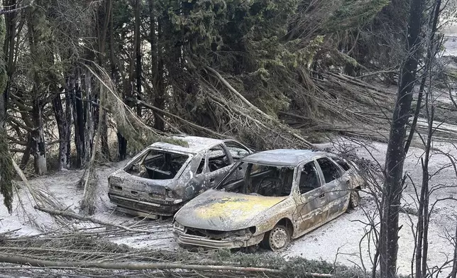 Cars are charred after a wildfire broke out near near Durban-Corbieres in southern France, Wednesday, Aug. 6, 2025. (AP Photo/Hernan Munoz)