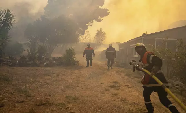 This photo provided by the Securite Civile shows firefighters battling a wildfire in a Mediterranean region near the Spanish border, southern France, Tuesday, Aug. 5, 2025. (Securite Civile via AP)