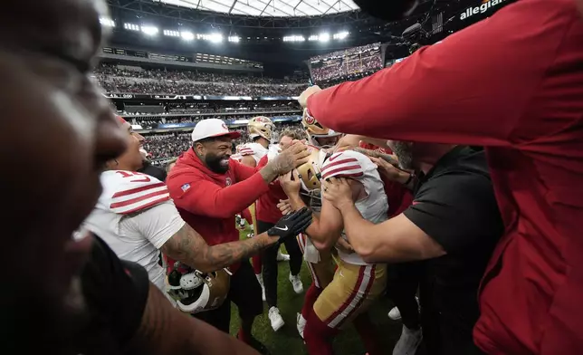 San Francisco 49ers place kicker Jake Moody is mobbed by teammates after making the game-winning field goal in a preseason NFL football game against the Las Vegas Raiders, Saturday, Aug. 16, 2025, in Las Vegas. (AP Photo/John Locher)