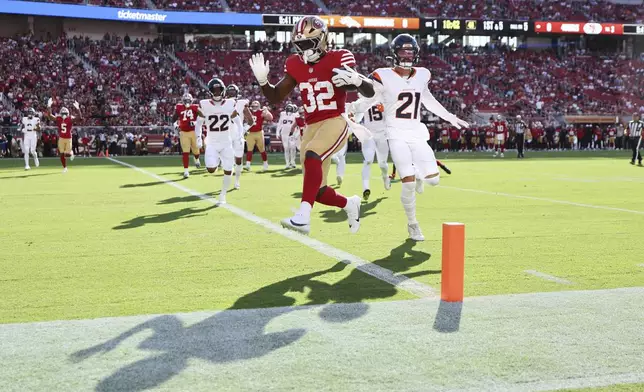 San Francisco 49ers running back Patrick Taylor Jr. (32) scores a touchdown during the first half of a preseason NFL football game against the Denver Broncos, Saturday, Aug. 9, 2025, in Santa Clara, Calif. (AP Photo/Kelley L Cox)