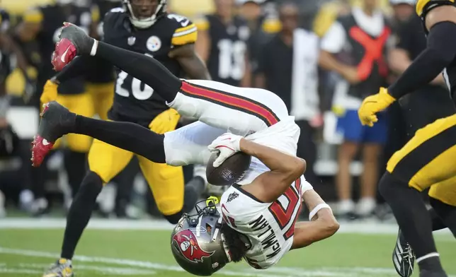 Tampa Bay Buccaneers wide receiver Jalen McMillan is upended by Pittsburgh Steelers cornerback Daryl Porter Jr. after catching a pass from quarterback Teddy Bridgewater during the first half of a preseason NFL football game, Saturday, Aug. 16, 2025, in Pittsburgh. (AP Photo/Sue Ogrocki)