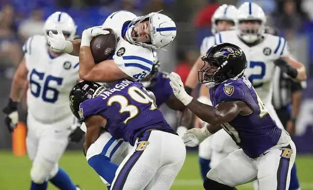 Indianapolis Colts tight end Sean McKeon, top left, is hit by Baltimore Ravens safety Keondre Jackson (39) as teammate Jay Higgins IV, right, helps defend during the second half of an NFL preseason football game Thursday, Aug. 7, 2025, in Baltimore. (AP Photo/Alex Brandon)