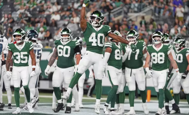 New York Jets running back Donovan Edwards (40) celebrates his touchdown in the second half of a preseason NFL football game against the Philadelphia Eagles in East Rutherford, N.J., Friday, Aug. 22, 2025. (AP Photo/Yuki Iwamura)
