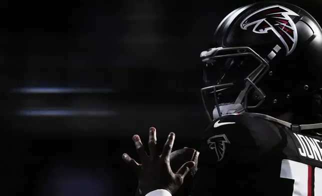 Atlanta Falcons quarterback Emory Jones warms up before an NFL preseason football game against the Detroit Lions Friday, Aug. 8, 2025, in Atlanta. (AP Photo/Brynn Anderson)