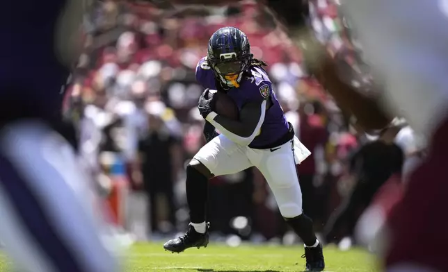 Baltimore Ravens running back D'Ernest Johnson runs with the ball during the first half of a preseason NFL football game against the Washington Commanders Saturday, Aug. 23, 2025, in Landover, Md. (AP Photo/Stephanie Scarbrough)