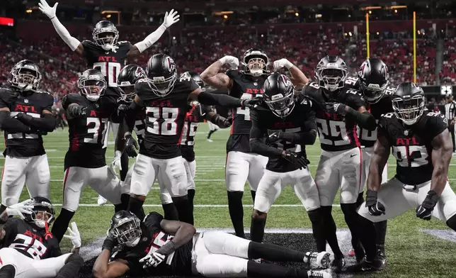 The Atlanta Falcons defense celebrates an interception by cornerback Natrone Brooks during the first half of a preseason NFL football game against the Tennessee Titans, Friday, Aug. 15, 2025, in Atlanta. (AP Photo/Brynn Anderson)