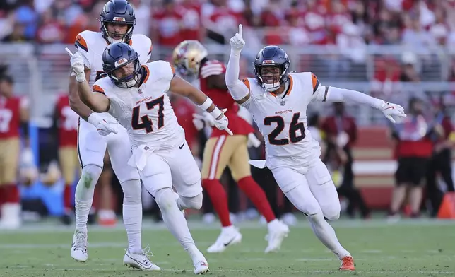 Denver Broncos linebacker Karene Reid (47) celebrates after intercepting a pass during the first half of a preseason NFL football game Saturday, Aug. 9, 2025, in Santa Clara, Calif. (AP Photo/Kelley L Cox)