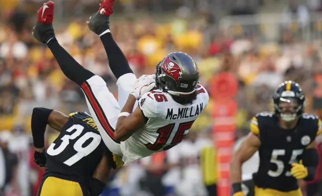 Tampa Bay Buccaneers wide receiver Jalen McMillan (15) is upended by Pittsburgh Steelers cornerback Daryl Porter Jr. (39) after making a catch during the first half of an NFL football preseason game, Saturday, Aug. 16, 2025 in Pittsburgh. (AP Photo/Matt Freed)