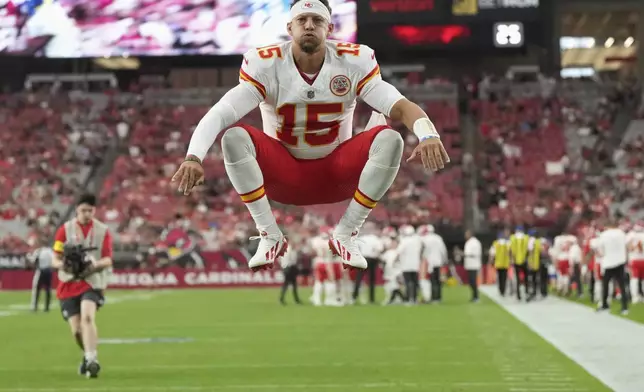 Kansas City Chiefs quarterback Patrick Mahomes jumps prior to an NFL preseason football game against the Arizona Cardinals, Saturday, Aug. 9, 2025, in Glendale. (AP Photo/Rick Scuteri)