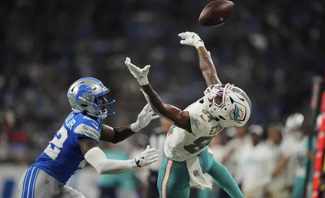 Miami Dolphins wide receiver Erik Ezukanma (84) leaps for a pass against Detroit Lions cornerback D.J. Miller Jr. (42) during the first half of an NFL preseason football game Saturday, Aug. 16, 2025, in Detroit. (AP Photo/Ryan Sun)