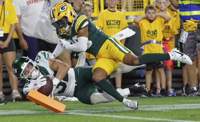 Green Bay Packers' Micah Robinson stops New York Jets' Isaiah Davis from scoring during the first half of a preseason NFL football game Saturday, Aug. 9, 2025, in Green Bay, Wis. (AP Photo/Mike Roemer)