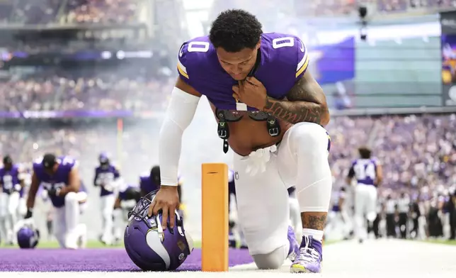 Minnesota Vikings linebacker Ivan Pace Jr. kneels before an NFL preseason football game against the Houston Texans, Saturday, Aug. 9, 2025, in Minneapolis. (AP Photo/Matt Krohn)
