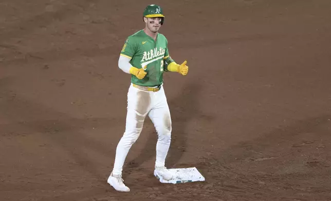 Athletics' Brent Rooker gives a thumbs-up after hitting a double during the fifth inning of a baseball game against the Detroit Tigers, Tuesday, Aug. 26, 2025, in West Sacramento, Calif. (AP Photo/Scott Marshall)