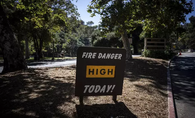 A sign warns of high fire danger at Griffith Park in Los Angeles, Tuesday, Aug. 19, 2025. (AP Photo/Jae C. Hong)