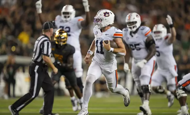 Auburn quarterback Jackson Arnold (11) runs for a touchdown against Baylor during the second half of an NCAA college football game Friday, Aug. 29, 2025, in Waco, Texas. (AP Photo/Julio Cortez)