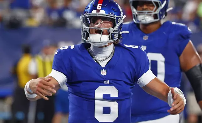 New York Giants quarterback Jaxson Dart (6) reacts after scoring a touchdown against the New York Jets during the third quarter of an NFL football game, Saturday, Aug. 16, 2025, in East Rutherford, N.J. (AP Photo/Noah K. Murray)