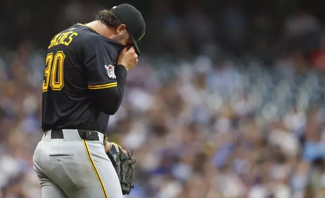 Pittsburgh Pirates starting pitcher Paul Skenes wipes his face during the fourth inning of a baseball game against the Milwaukee Brewers, Tuesday, Aug.12, 2025, in Milwaukee. (AP Photo/Jeffrey Phelps)
