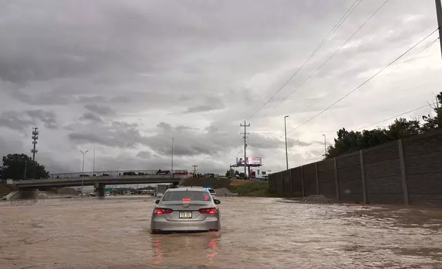 Cars struggle through floodwaters the eastbound lanes of US Interstate 24, in Chattanooga, Tenn., on Aug. 12, 2025. (Robin Rudd/Chattanooga Times Free Press via AP)