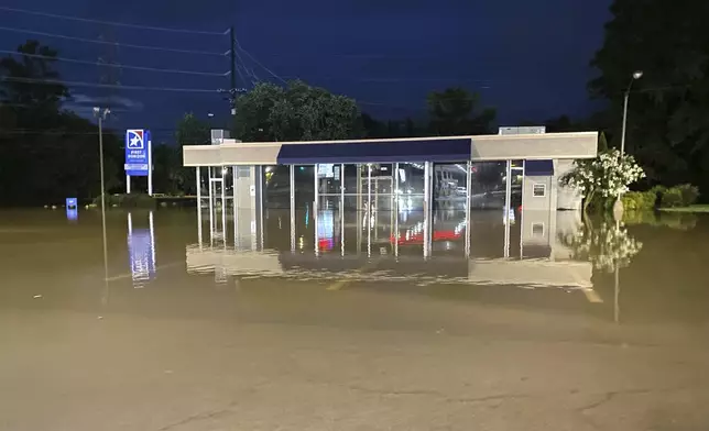 The East Brainerd branch of First Horizon Bank is flooded by the waters of Mackey Branch, in Chattanooga, Tenn., on Aug. 12, 2025. (Robin Rudd/Chattanooga Times Free Press via AP)