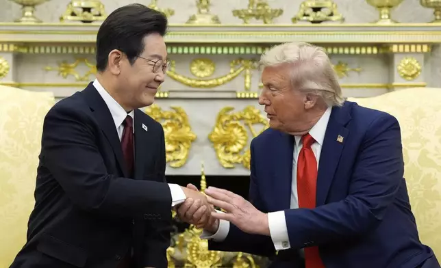 President Donald Trump, right, shakes the hand of South Korean President Lee Jae Myung during a meeting in the Oval Office of the White House, Monday, Aug. 25, 2025, in Washington. (AP Photo/Alex Brandon)