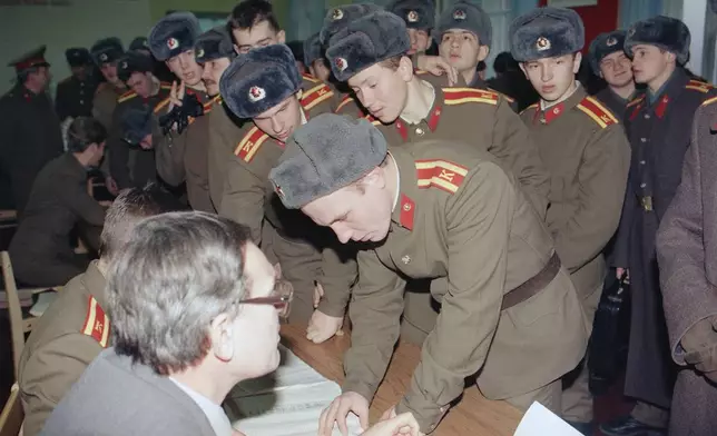 Soviet army cadets register to vote in the Ukraine's first popular presidential election in Kyiv, Dec. 1, 1991. (AP Photo/Liu Heung Shing, File)