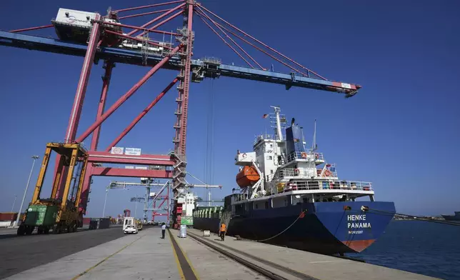 Containers loaded with humanitarian aid for the people of Gaza, including flour, pasta, baby food and canned goods, is being loaded aboard a Panamanian-flagged ship at Cyprus' main port in Limassol, on Monday, Aug. 18, 2025. (AP Photo/Petros Karadjias)