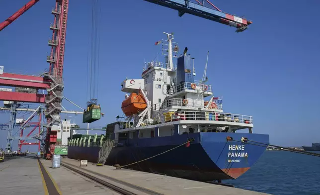 Containers loaded with humanitarian aid for the people of Gaza, including flour, pasta, baby food and canned goods, is being loaded aboard a Panamanian-flagged ship at Cyprus' main port in Limassol, on Monday, Aug. 18, 2025. (AP Photo/Petros Karadjias)