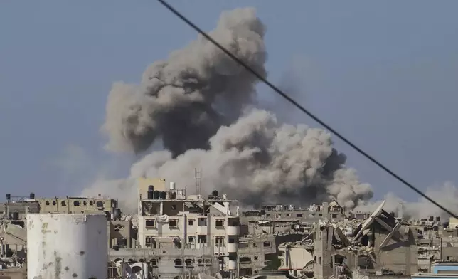 Smoke rises to the sky following an Israeli army airstrike in Khan Younis, in the Gaza Strip, Monday, Aug. 18, 2025. (AP Photo/Mariam Dagga)