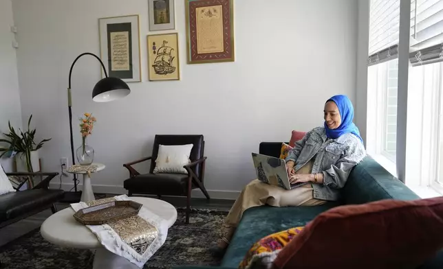 Hoda Abrahim, founder and CEO of Love, Inshallah, a matchmaker featured on the series "Muslim Matchmaker," on Hulu, works on her computer at her home on Monday, Aug. 11, 2025, in Conroe, Texas. (AP Photo/Ashley Landis)