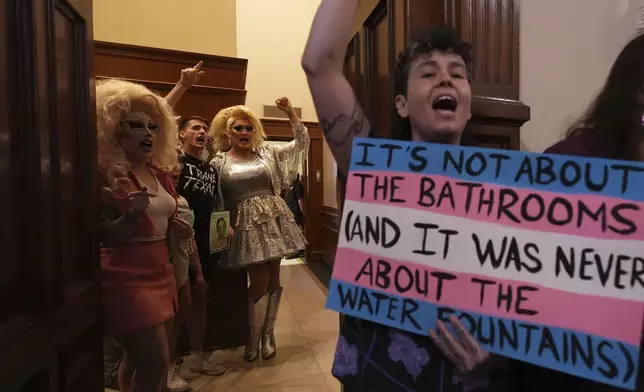 Protesters take over a women's restroom as they speak out against an anti-transgender bathroom bill at the Texas Capitol in Austin, Texas, Friday, Aug. 22, 2025. (AP Photo/Eric Gay)