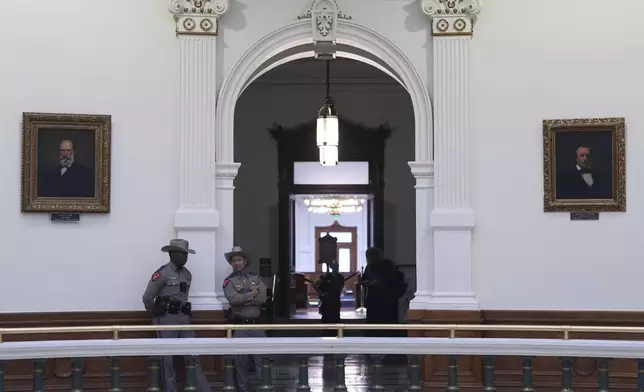 Texas troopers stand watch in the Rotunda of the Texas Capitol before debate on a bill on a redrawn U.S. congressional map during a special session in the Senate Chamber in Austin, Texas, Friday, Aug. 22, 2025. (AP Photo/Eric Gay)