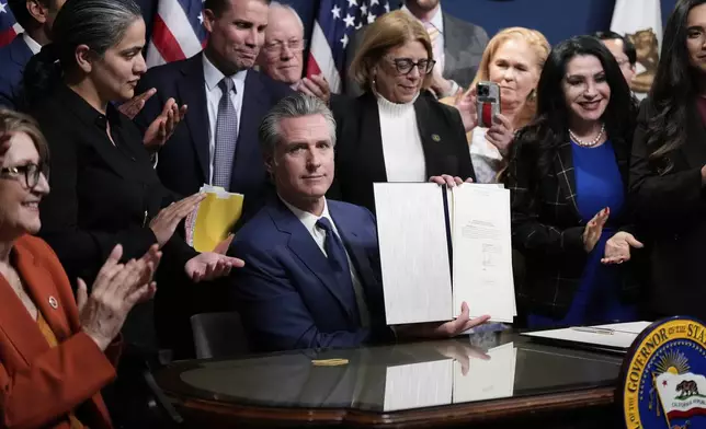 California Gov. Gavin Newsom signs legislation calling for a special election on a redrawn congressional map on Thursday, Aug. 21, 2025, in Sacramento, Calif. (AP Photo/Godofredo A. Vásquez)