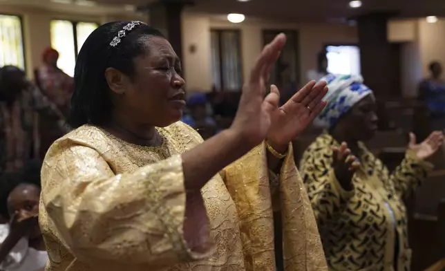 Perpetua Nsabimana, wife of the Rev. Daniel Niyonzima, prays during service at St. Paul's United Methodist Church on Sunday, Aug. 9, 2025, in Cedar Rapids, Iowa. (AP Photo/Jessie Wardarski)