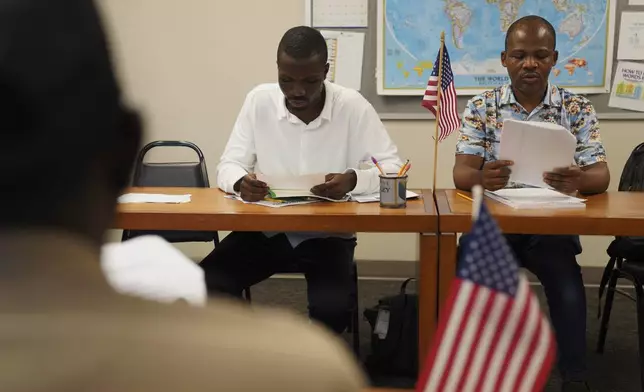Five men from China, Benin, Congo, Togo and Sudan, and a Guatemalan woman and her son, take a citizenship class at The Catherine McAuley Center, founded by the Catholic Sisters of Mercy order, on Saturday, Aug. 9, 2025, in Cedar Rapids, Iowa. (AP Photo/Jessie Wardarski)