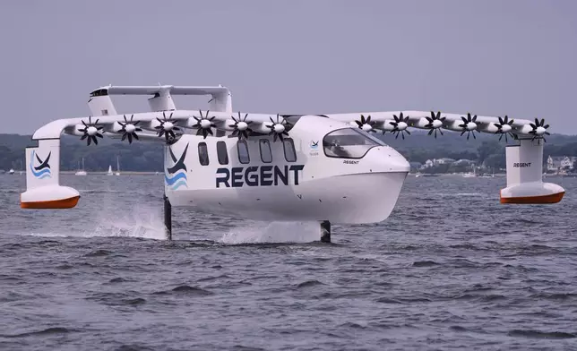 The REGENT Viceroy Seaglider, a winged passenger ferry, glides over the surface of Narragansett Bay on a test run, Wednesday, Aug. 6, 2025, off the coast of North Kingstown, R.I. (AP Photo/Charles Krupa)