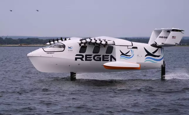 The REGENT Viceroy Seaglider, a winged passenger ferry, glides over the surface of Narragansett Bay on a test run, Wednesday, Aug. 6, 2025, off the coast of North Kingstown, R.I. (AP Photo/Charles Krupa)