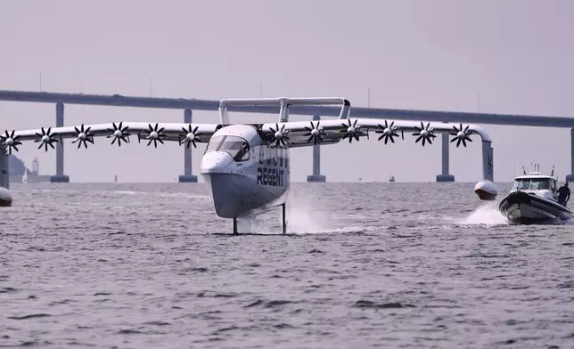 The REGENT Viceroy Seaglider, a winged passenger ferry, glides over the surface of Narragansett Bay on a test run, Wednesday, Aug. 6, 2025, off the coast of North Kingstown, R.I. (AP Photo/Charles Krupa)