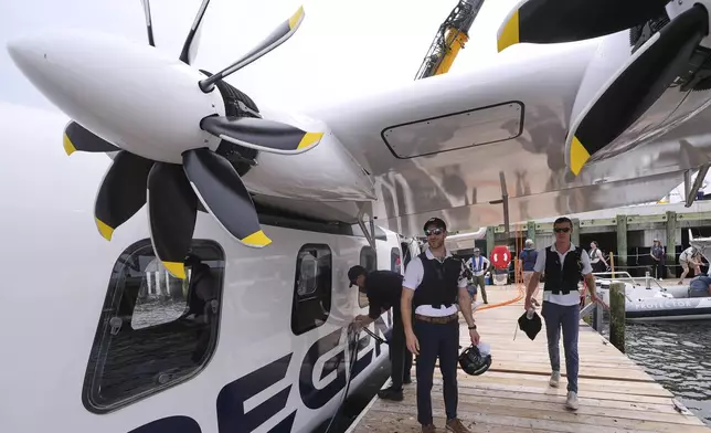 Billy Thalheimer, CEO and Co-Founder of REGENT, left, and Mike Klinker, CTO and Co-Founder of REGENT, walk on a dock after piloting the Viceroy Seaglider, a winged passenger ferry, following a test run on Narragansett Bay, Wednesday, Aug. 6, 2025, in North Kingstown, R.I. (AP Photo/Charles Krupa)