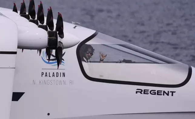 Billy Thalheimer, CEO and Co-Founder of REGENT, gestures after piloting the Viceroy Seaglider, a winged passenger ferry, following a test run on Narragansett Bay, Wednesday, Aug. 6, 2025, off the coast of North Kingstown, R.I. (AP Photo/Charles Krupa)