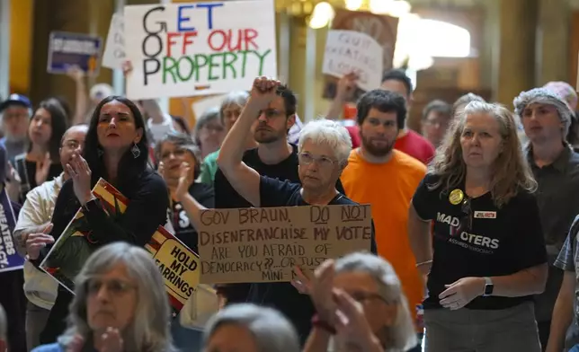 Protestors, including Linda Lynn, Cent, of Indianapolis, cheer during a really against redistricting at the Indiana Statehouse in Indianapolis, Thursday, Aug. 7, 2025. (AP Photo/Michael Conroy)
