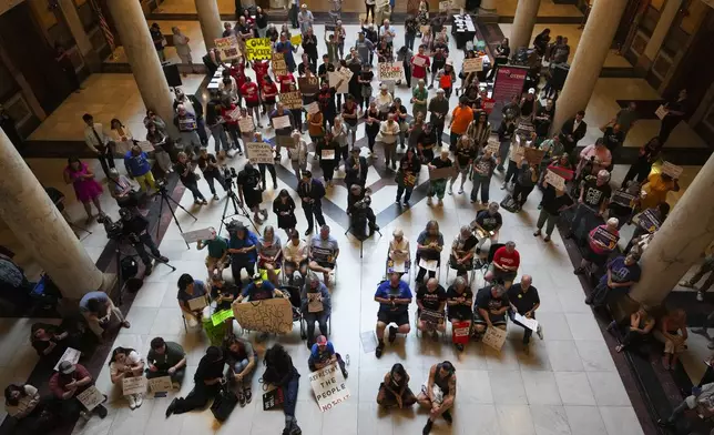 Protestors cheer during a really against redistricting at the Indiana Statehouse in Indianapolis, Thursday, Aug. 7, 2025. (AP Photo/Michael Conroy)